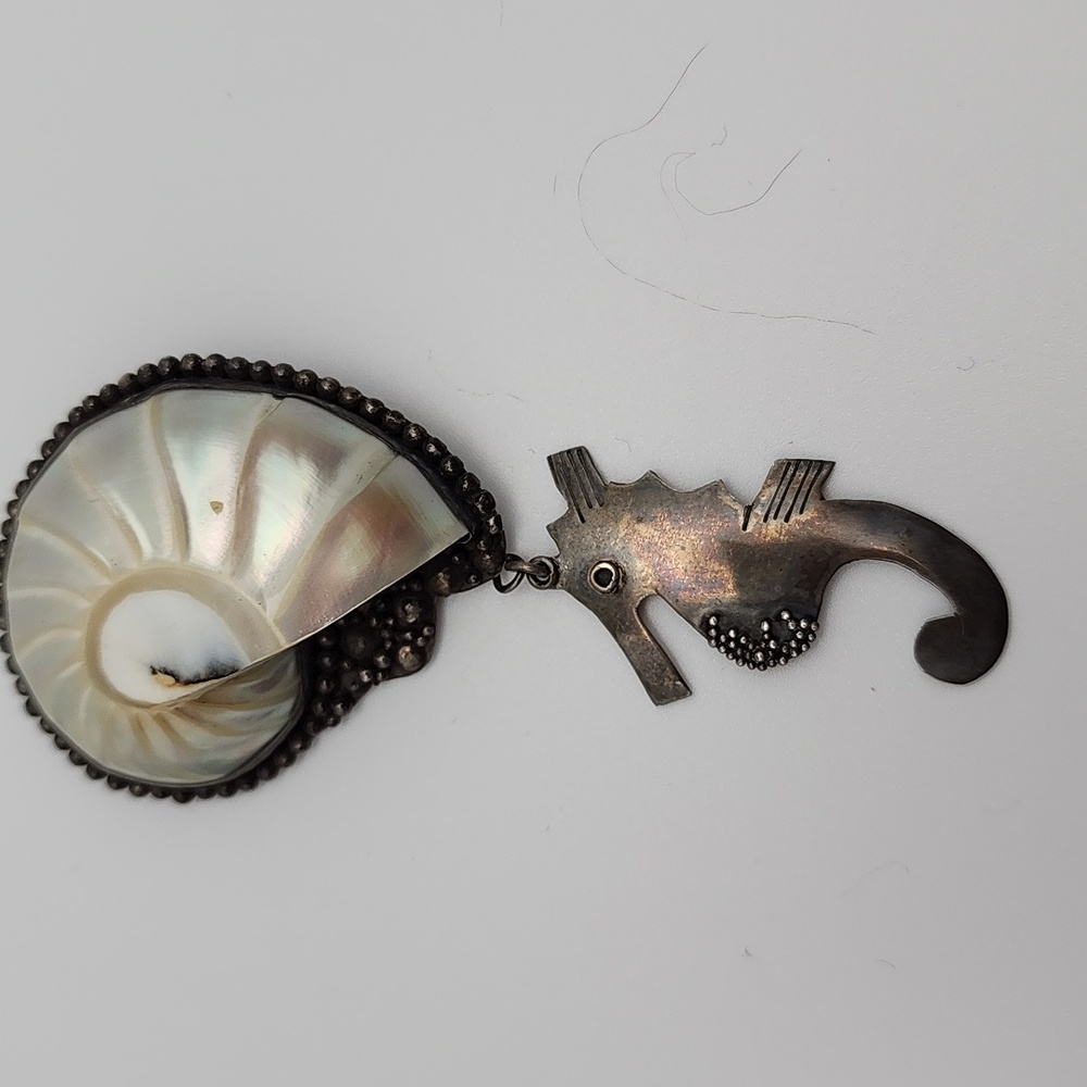 Gorgeous Nautilus Shell set in Sterling with dangling sterling Seahorse.